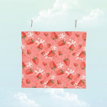 Back view of the pink strawberry print hanging hay bag for small pets