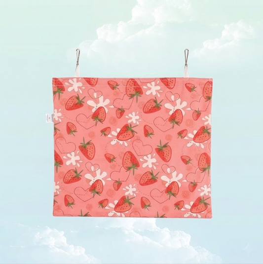Back view of the pink strawberry print hanging hay bag for small pets